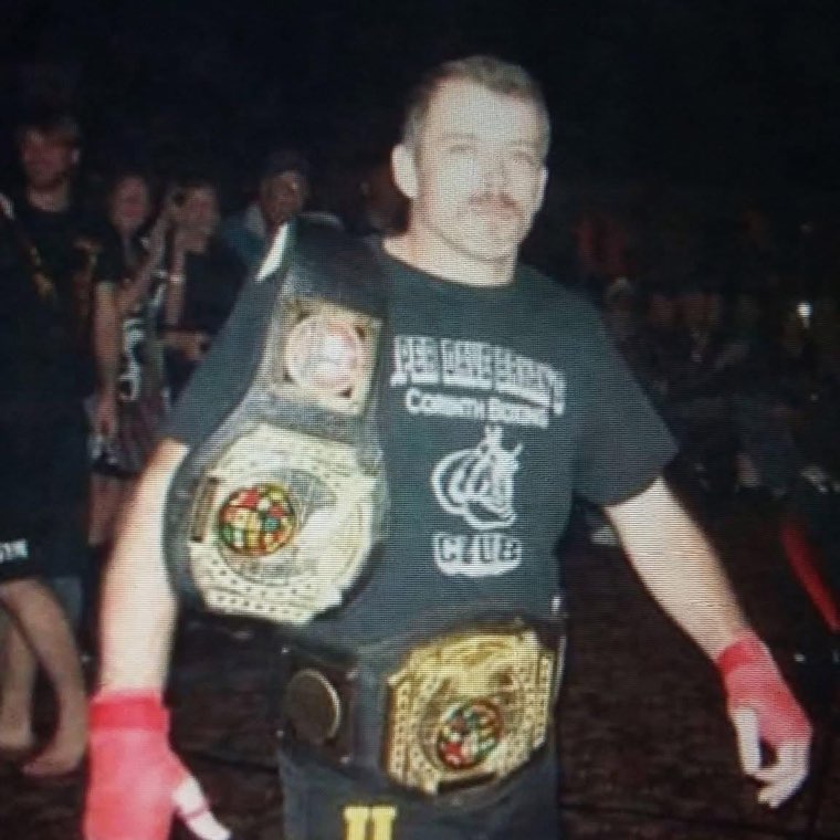 David Bryan with MMA championship belts